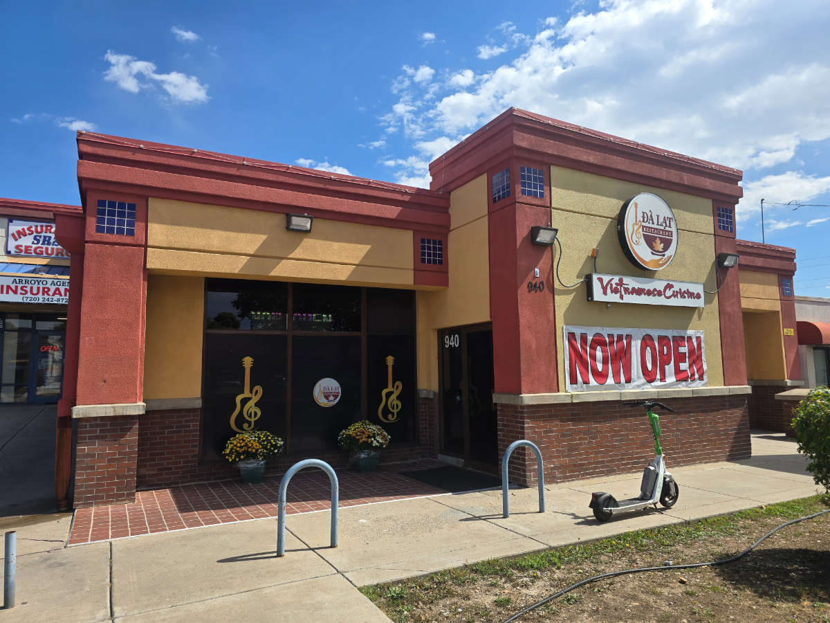 "now open" banner on a building