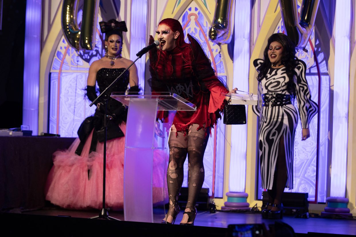 A drag queen gives a speech on stage