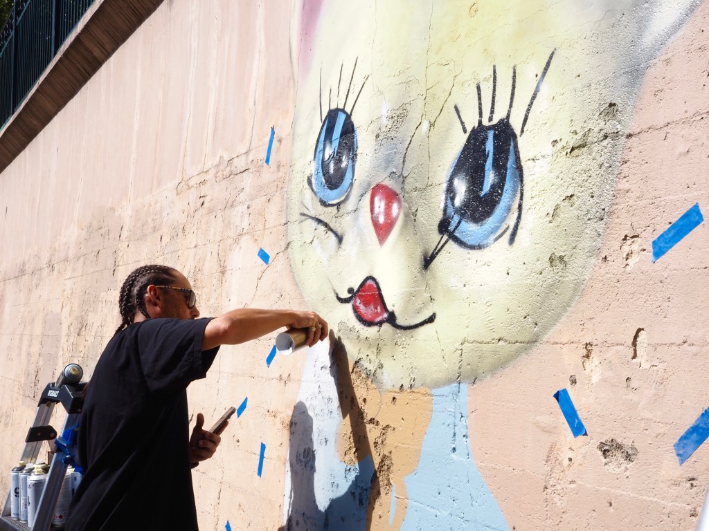 A man spray paints a wall