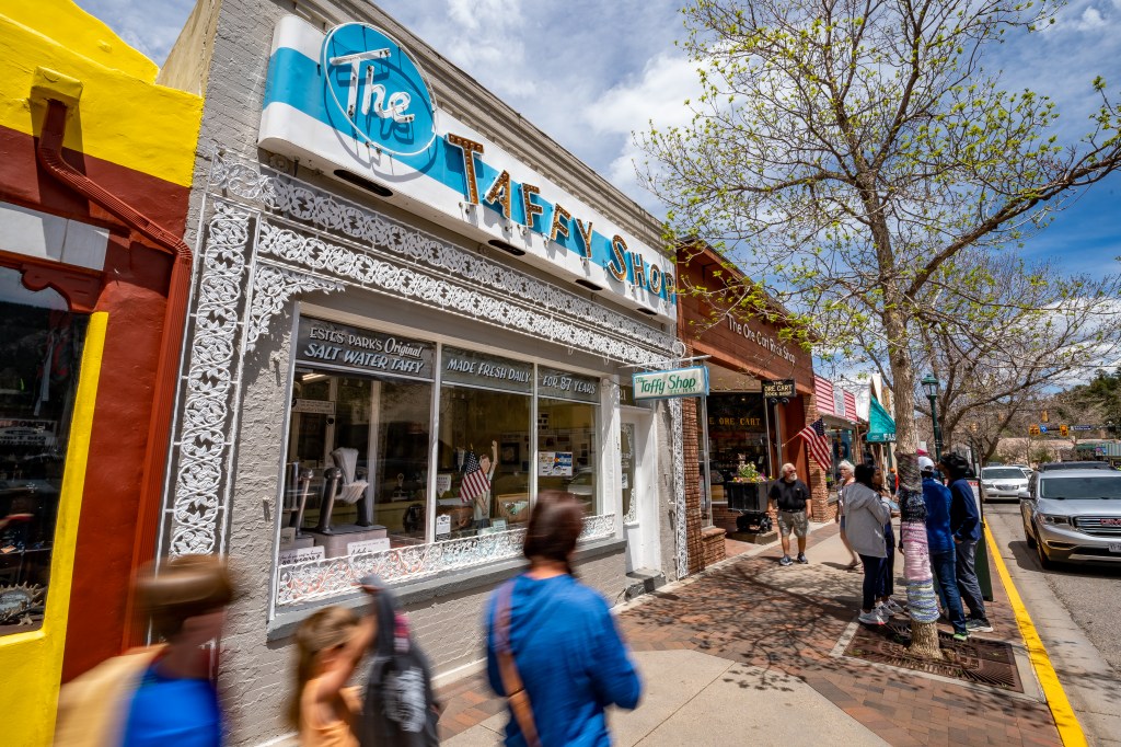 The white and blue exterior of a taffy shop on Elkhorn Avenue in Estes Park