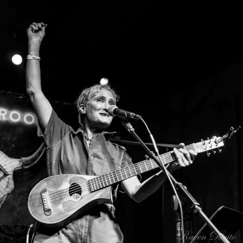 Denver musician Jill Sobule with a guitar on stage.