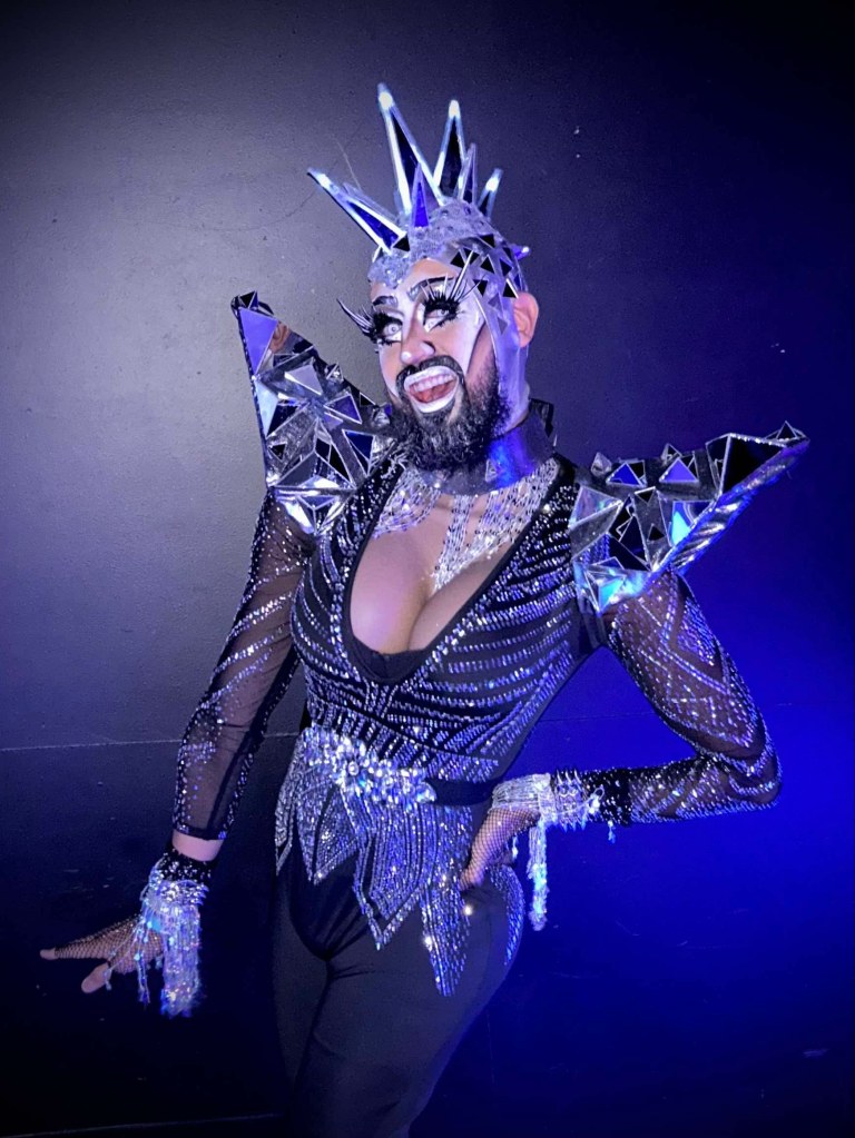 A drag queen in a silver suit