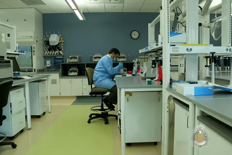 A man works inside of a lab at the Denver Crime Laboratory.
