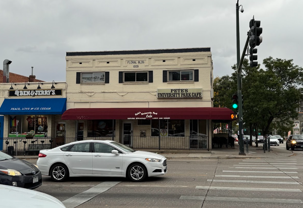 exterior of a tan building with a red awning