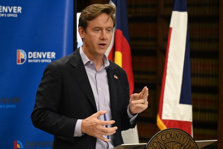 Mayor Mike Johnston talks to the press.