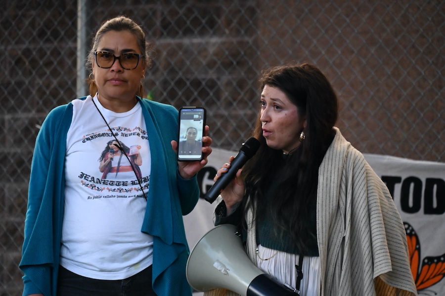 A woman holds up a phone.