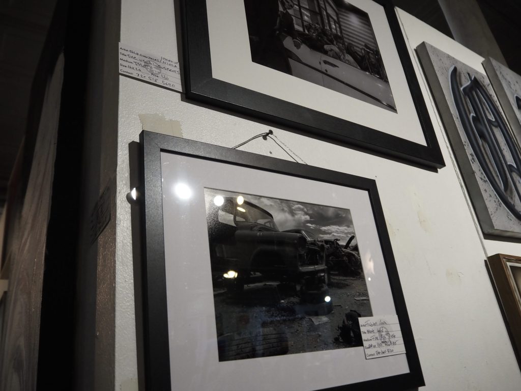 Black and white photos hang on a wall