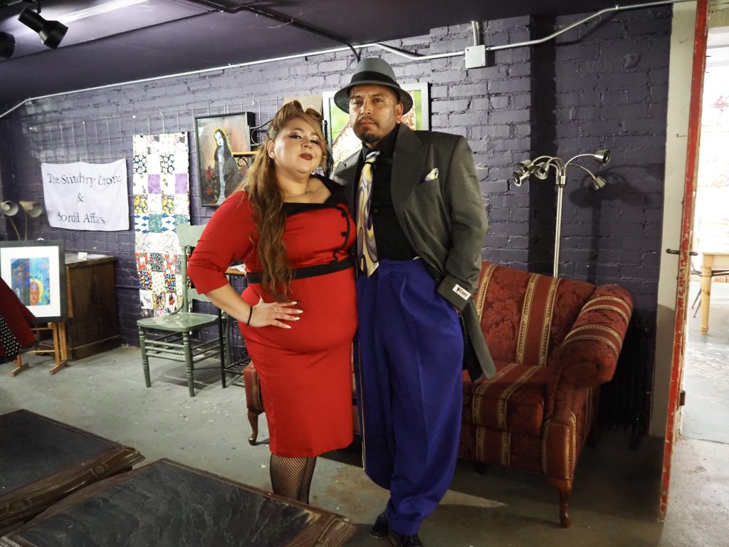 A woman in a red dress and a man in a zoot suit