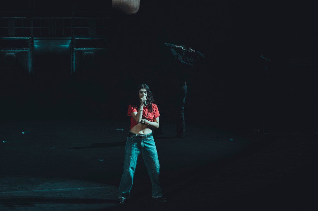Lorde on stage at Red Rocks strip teasing the crowd.