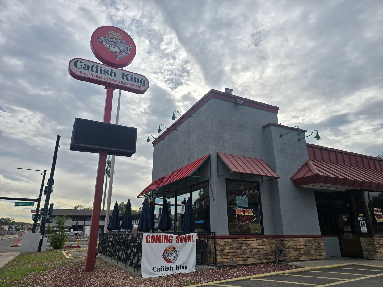 grey building with a Catfish King sign in front