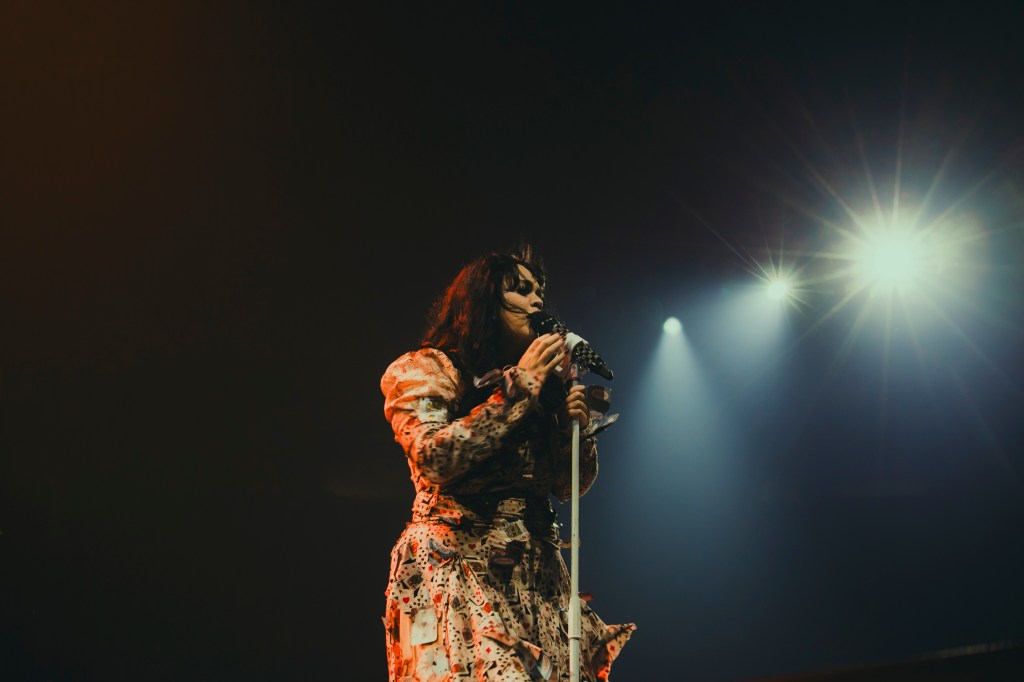 Amira Elfeky on stage at Ball Arena opening for The Plot in You.