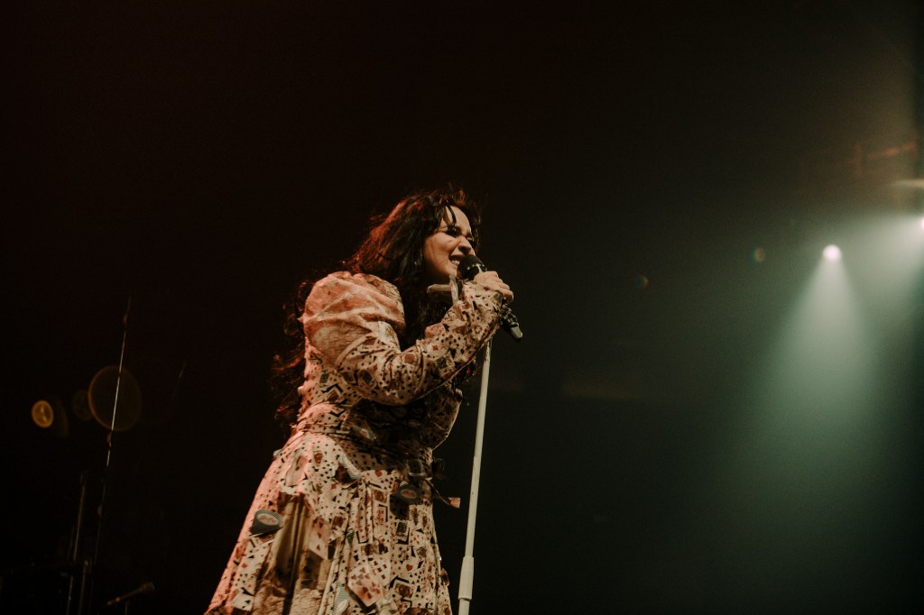 Amira Elfeky on stage at Ball Arena opening for The Plot in You.