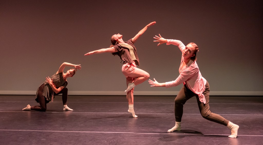 People dance onstage in an experimental manner.