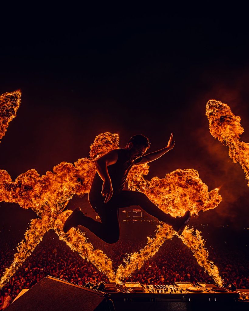 Martin Garrix jumping in front of fire