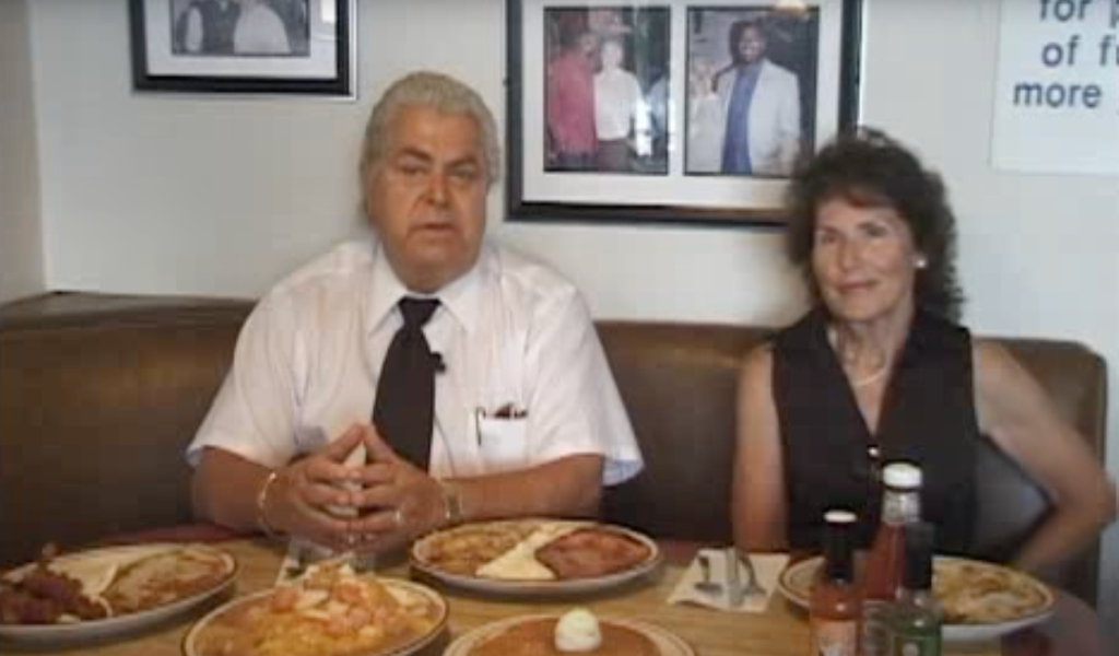 Two people sit at a diner table