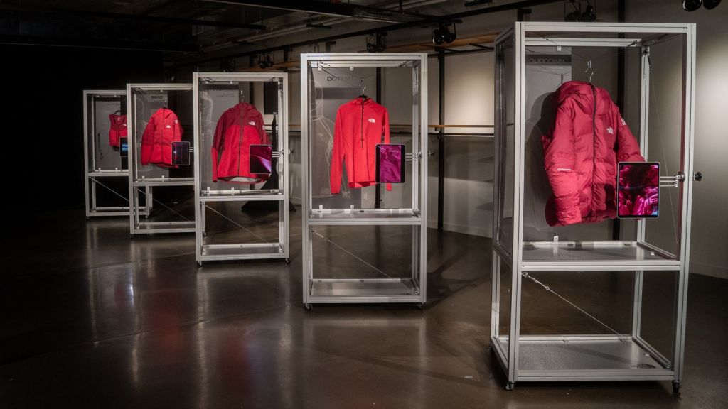 Layers part of the women's Summit Series Advanced Mountain Kit hanging on display racks