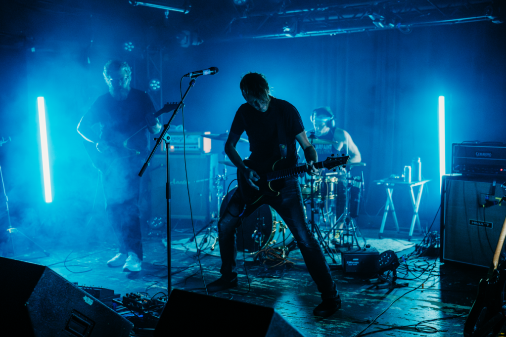 band on stage with blue lighting
