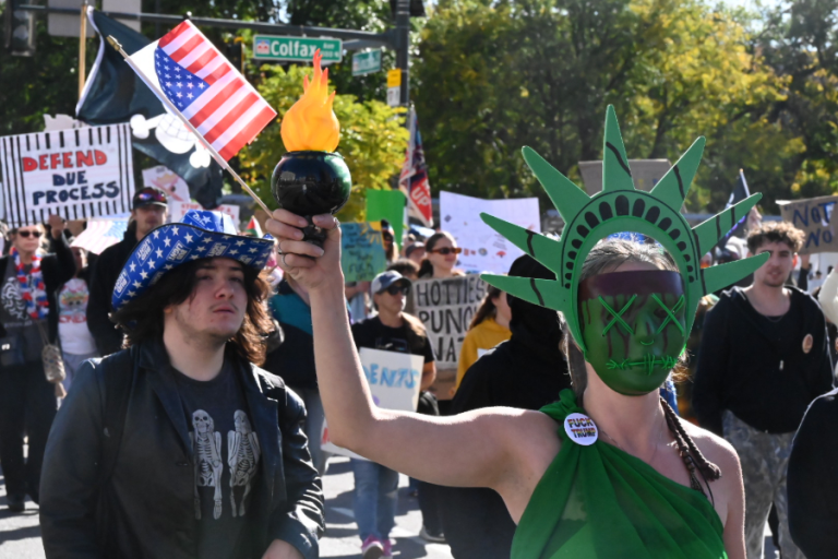 women in statue of liberty costume during Denver protest