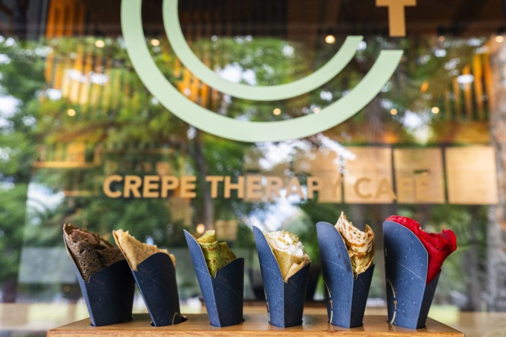 various crepes lined up in front of a window