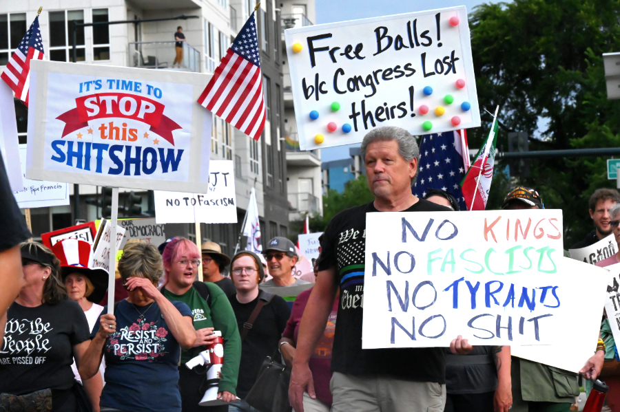 Protesters walking with signs.