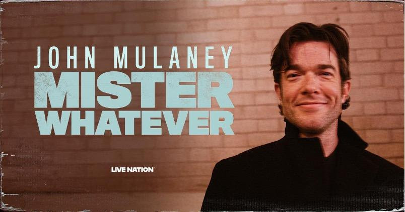 John Mulaney against a brick wall with blue letters reading "John Mulaney Mister Whatever"