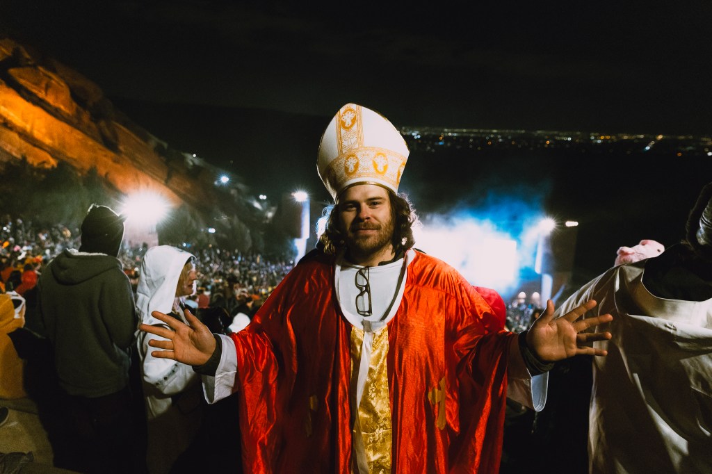 A photo showing a concertgoer dressed as the The Pope.