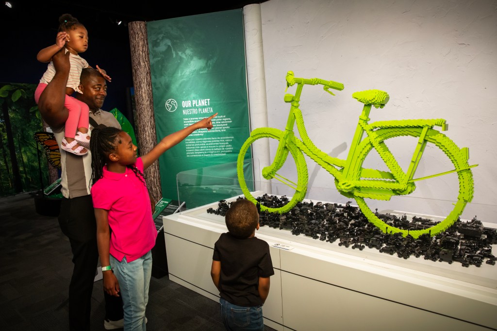 A green bicycle constructed from LEGOs.