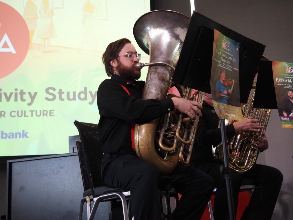 a person plays a tuba
