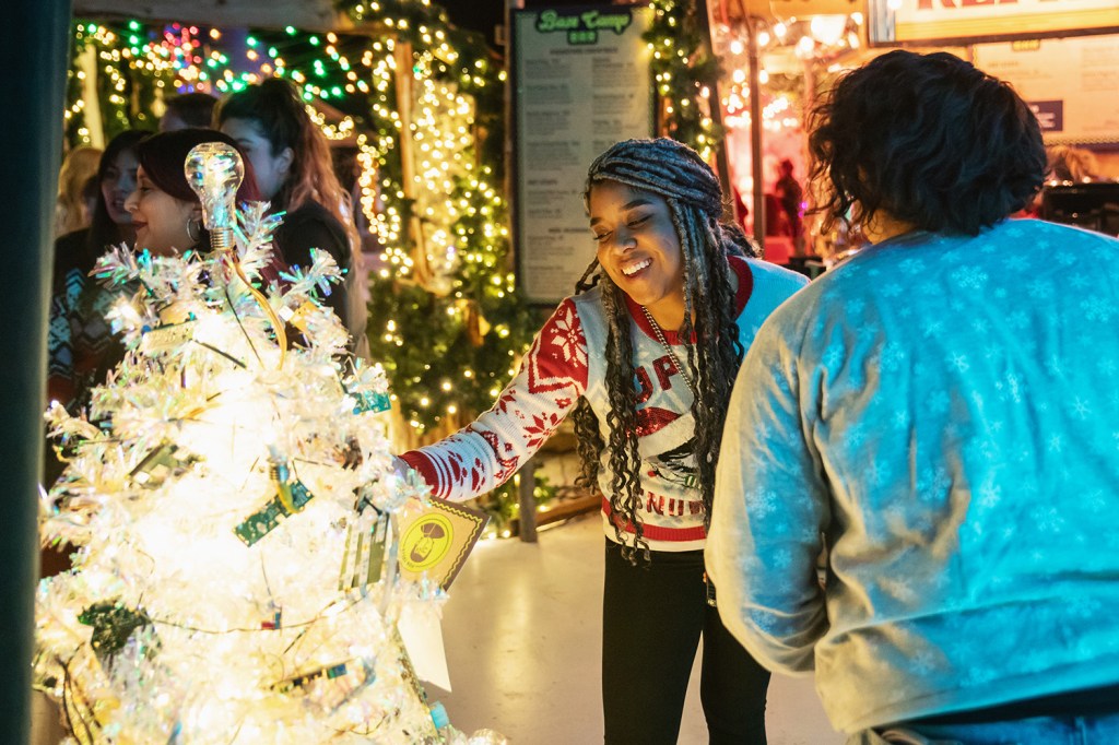 People look at the Christmas tree with a pun on it.
