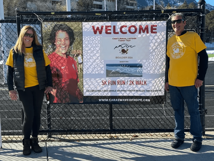 People stand around a fence