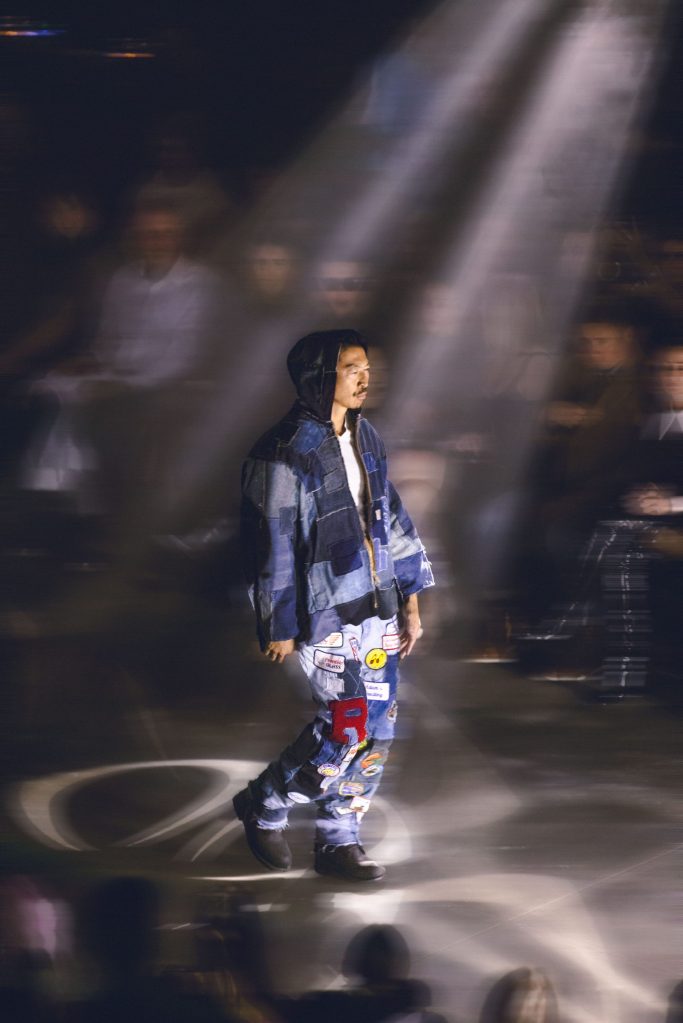Model walking Denver Fashion Week in Ryuju Collective signature patchwork denim