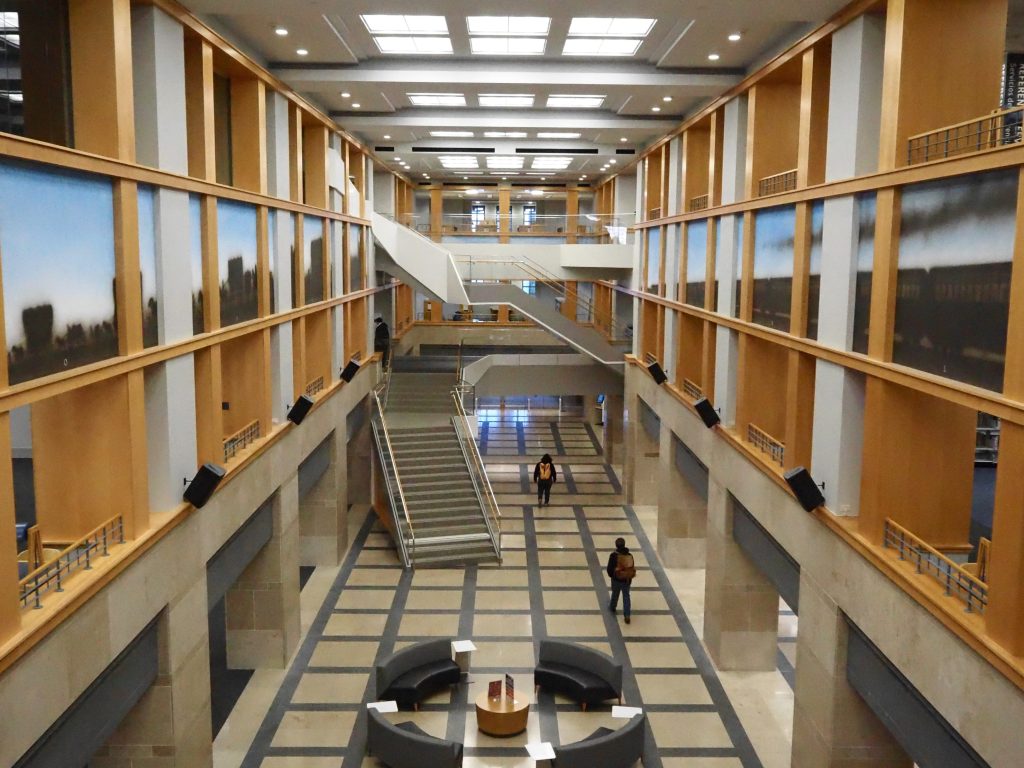 people walk in a large library