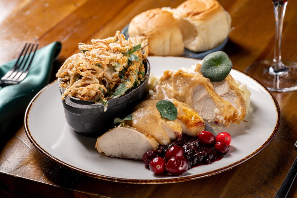 A plate of sliced turkey with gravy, green bean casserole and cranberry sauce from Local Jones at the Halcyon hotel