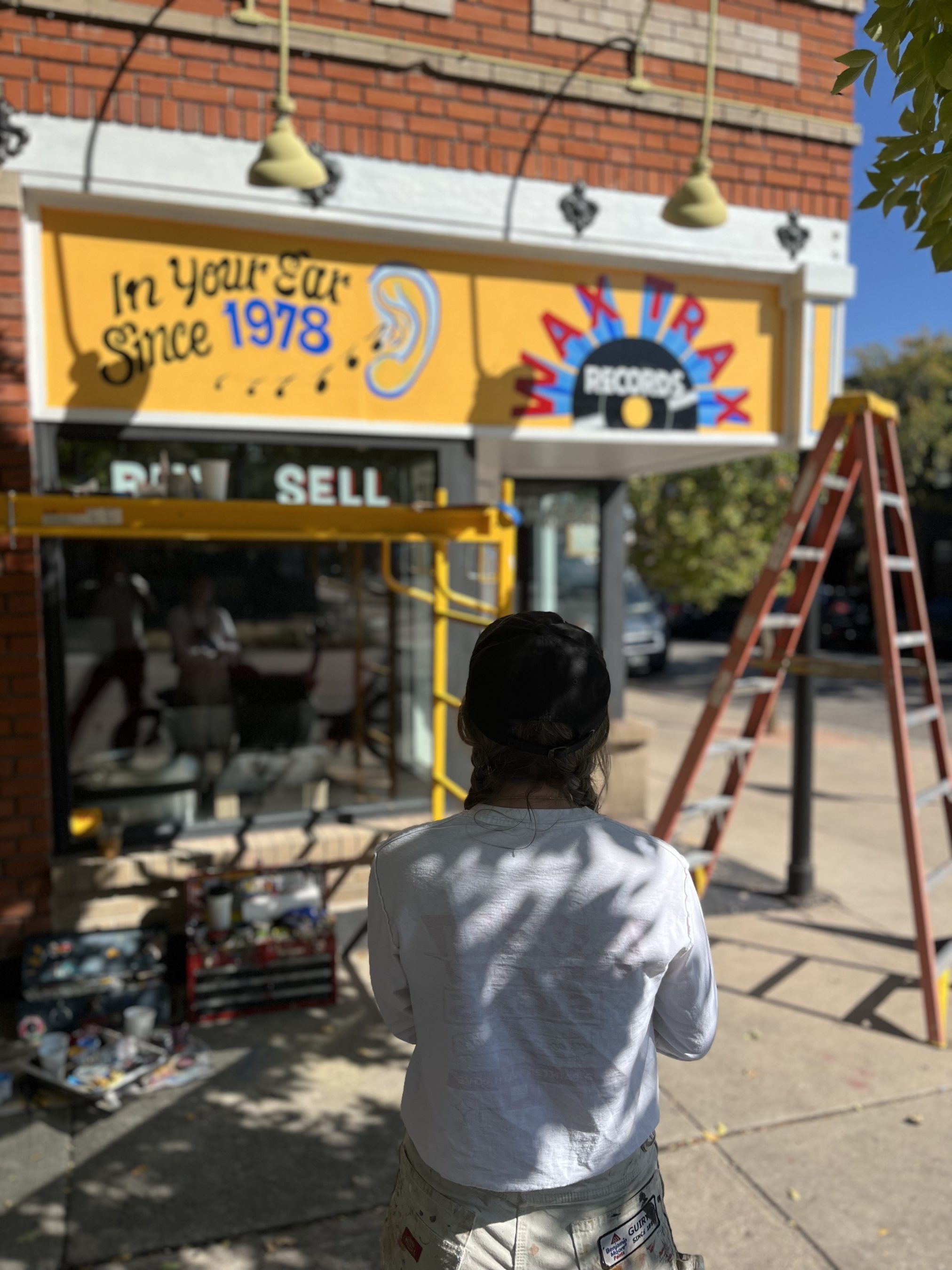 Sign band captioned ''In Your Ear Since 1978" and "WAX TRAX RECORDS".
