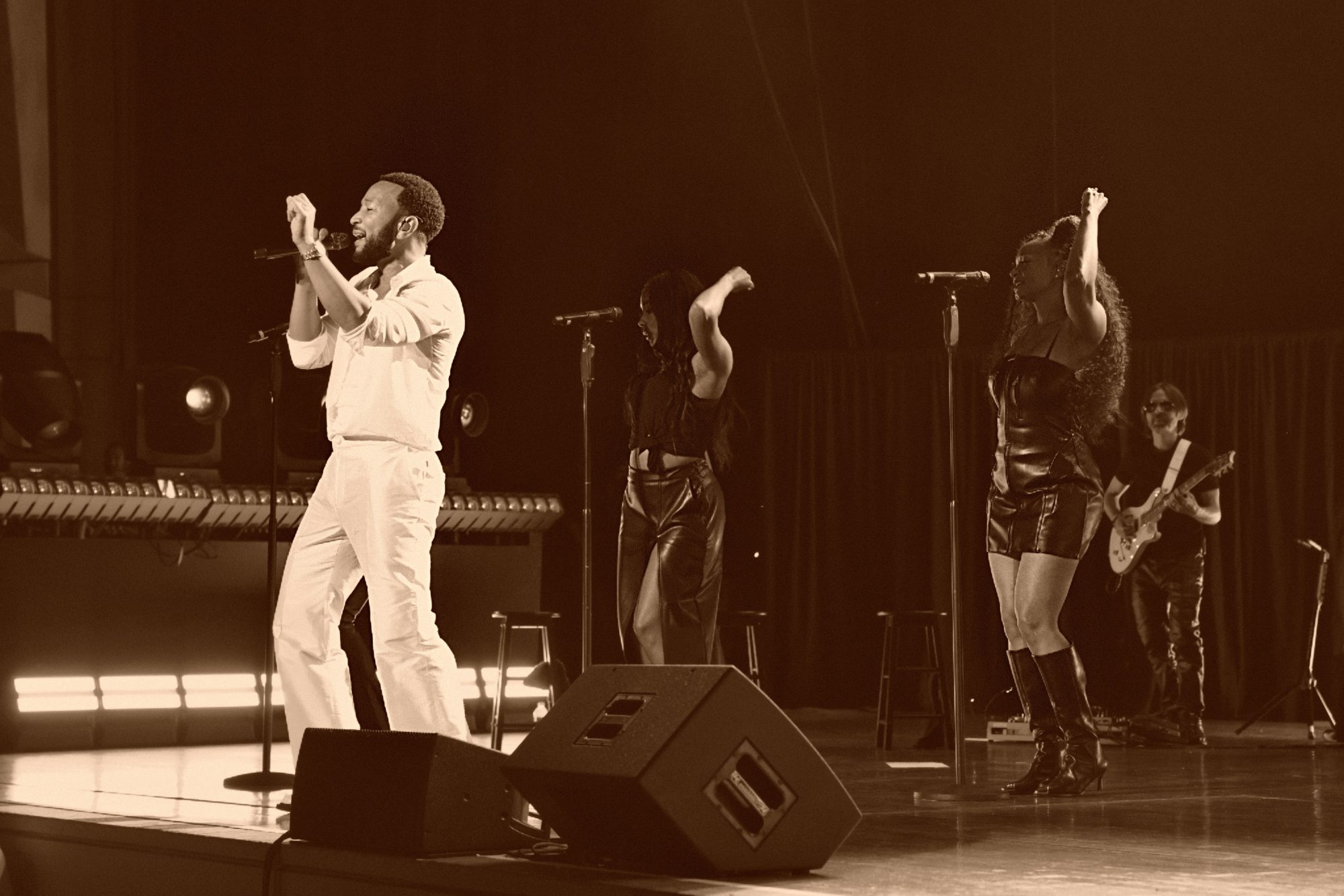 John Legend performing on stage.