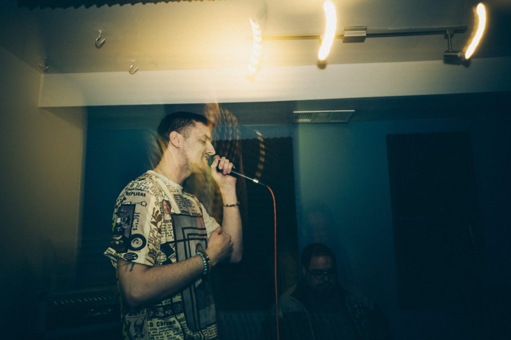 man rapping at a mic