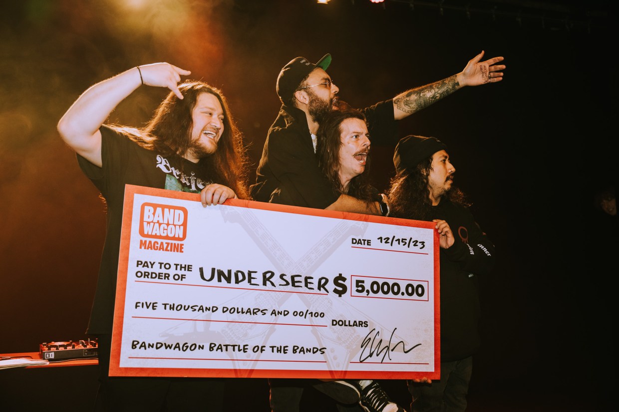 band holding a giant check