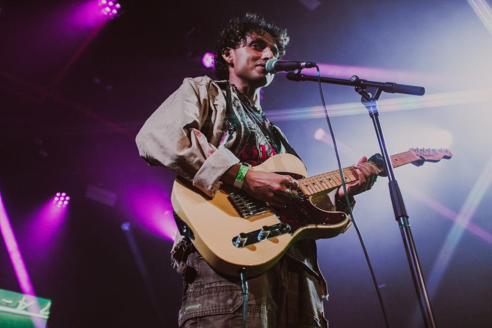 man with a guitar at the mic