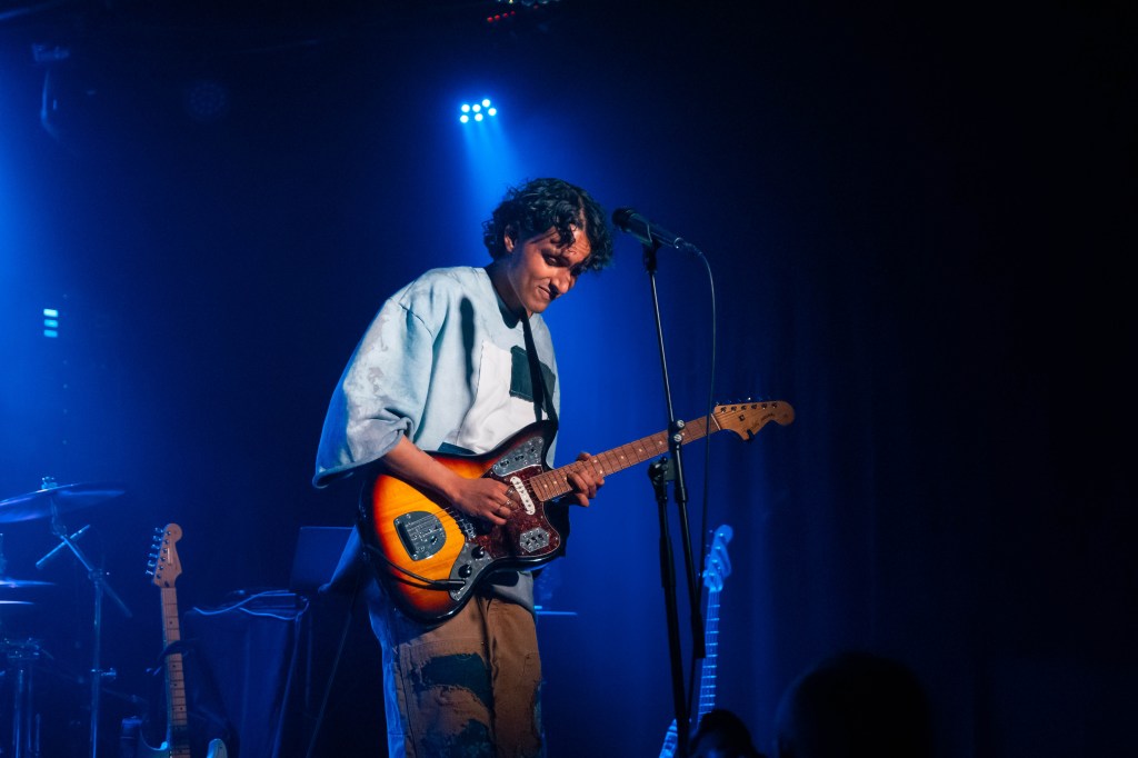 man playing guitar on stage