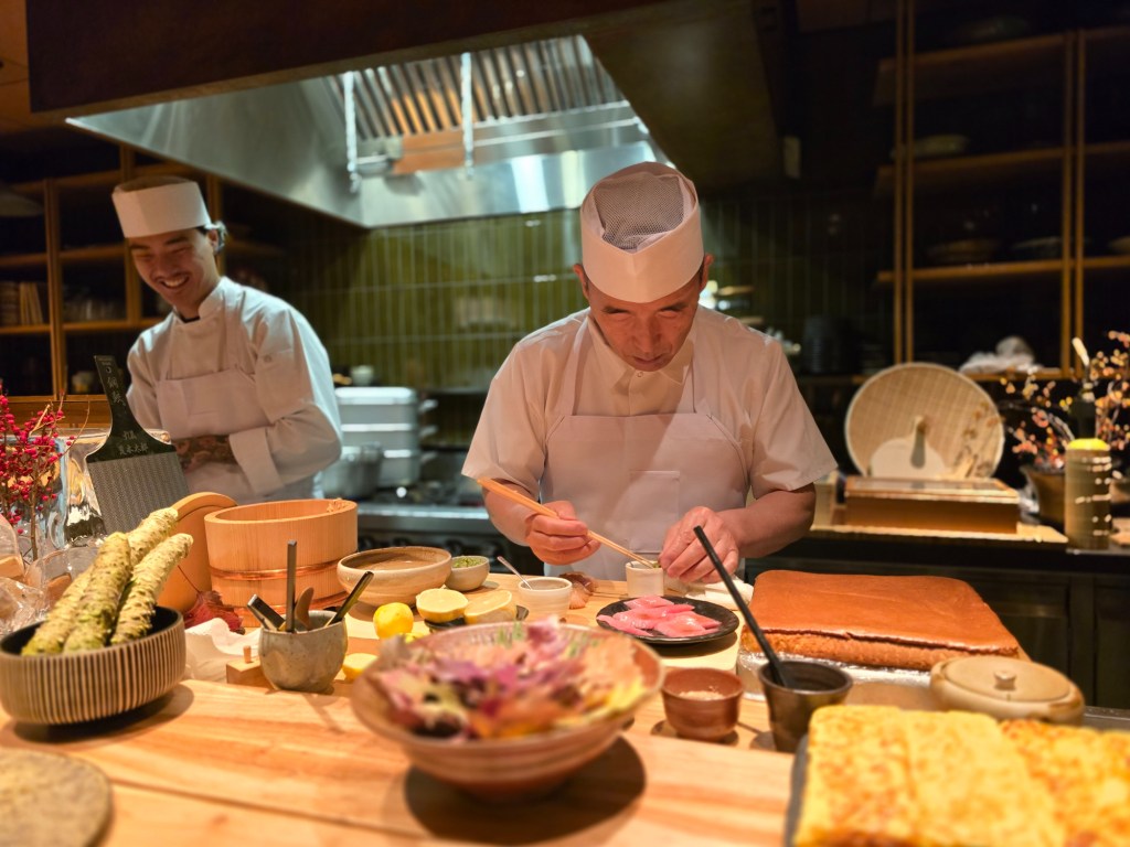 chef behind a sushi counter