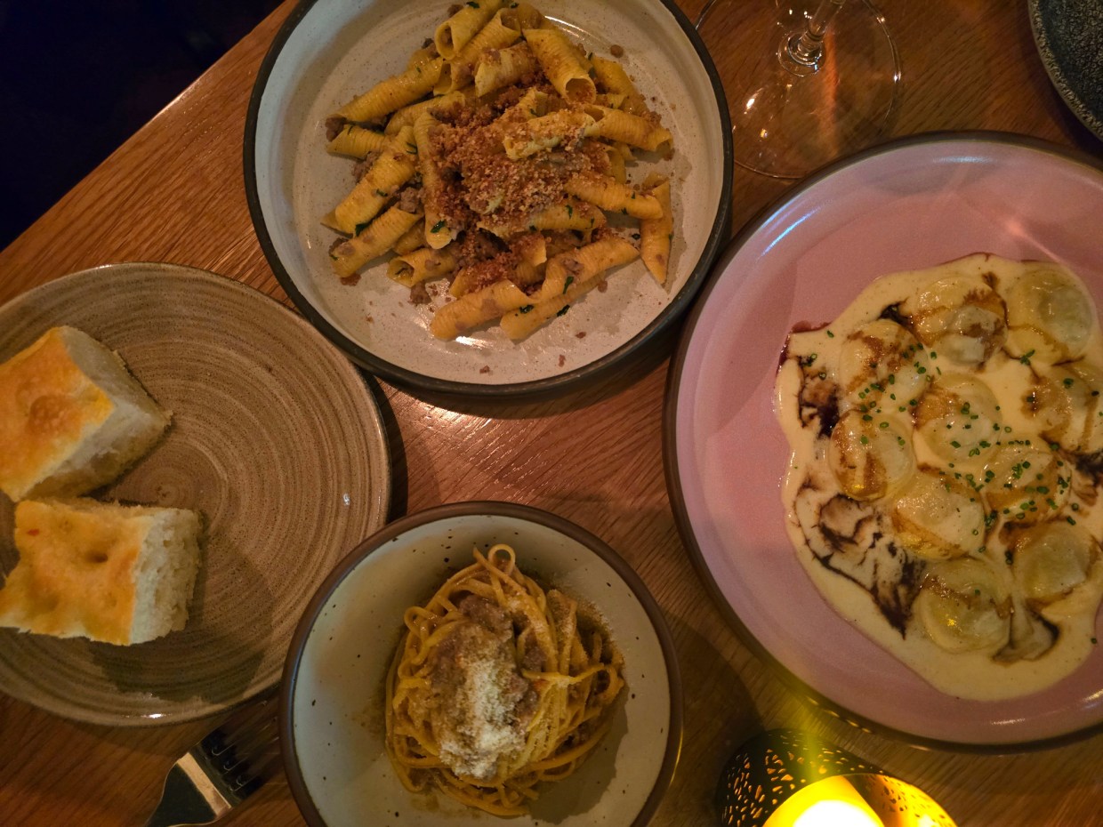 three pasta dishes on a table