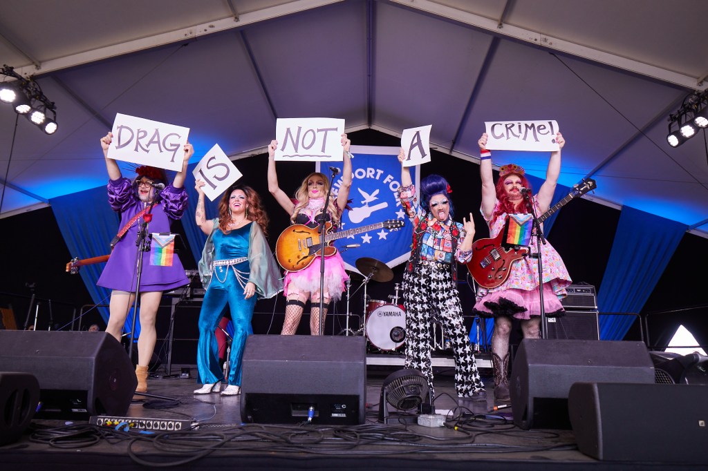 Bertha: Grateful Drag holding pro-drag signs