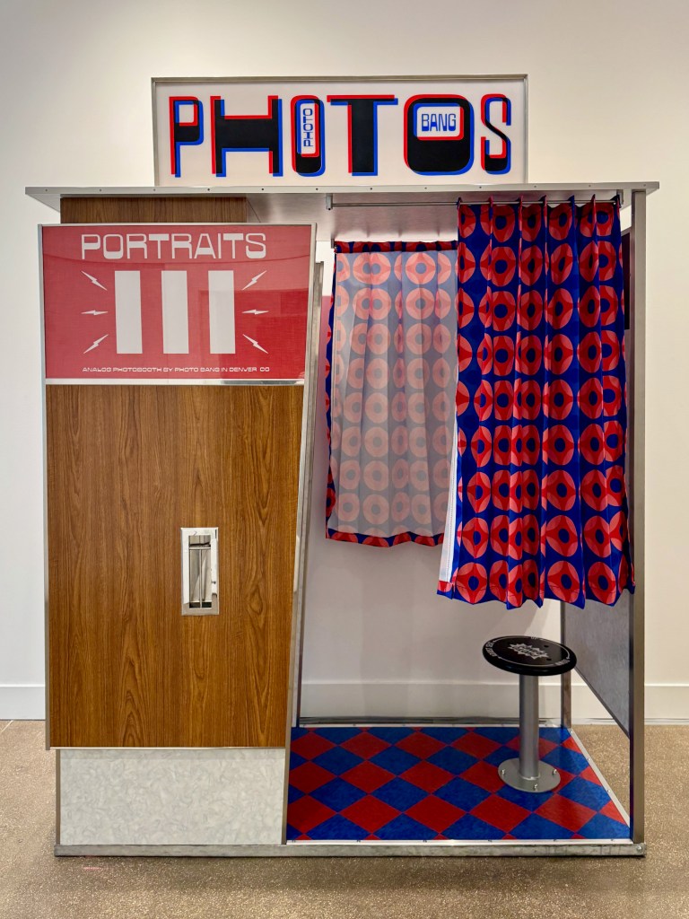 A photobooth with a red curtain