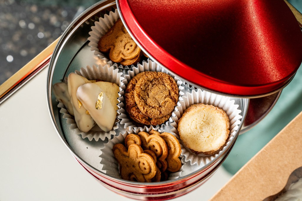 An assortment of holiday cookies in a red metal tin from the Halcyon hotel's bake shop