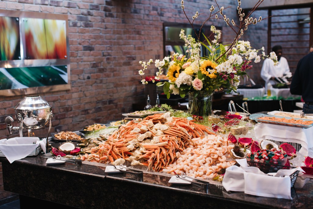 The raw bar at Inverness Denver featuring snow crab legs and poached shrimp