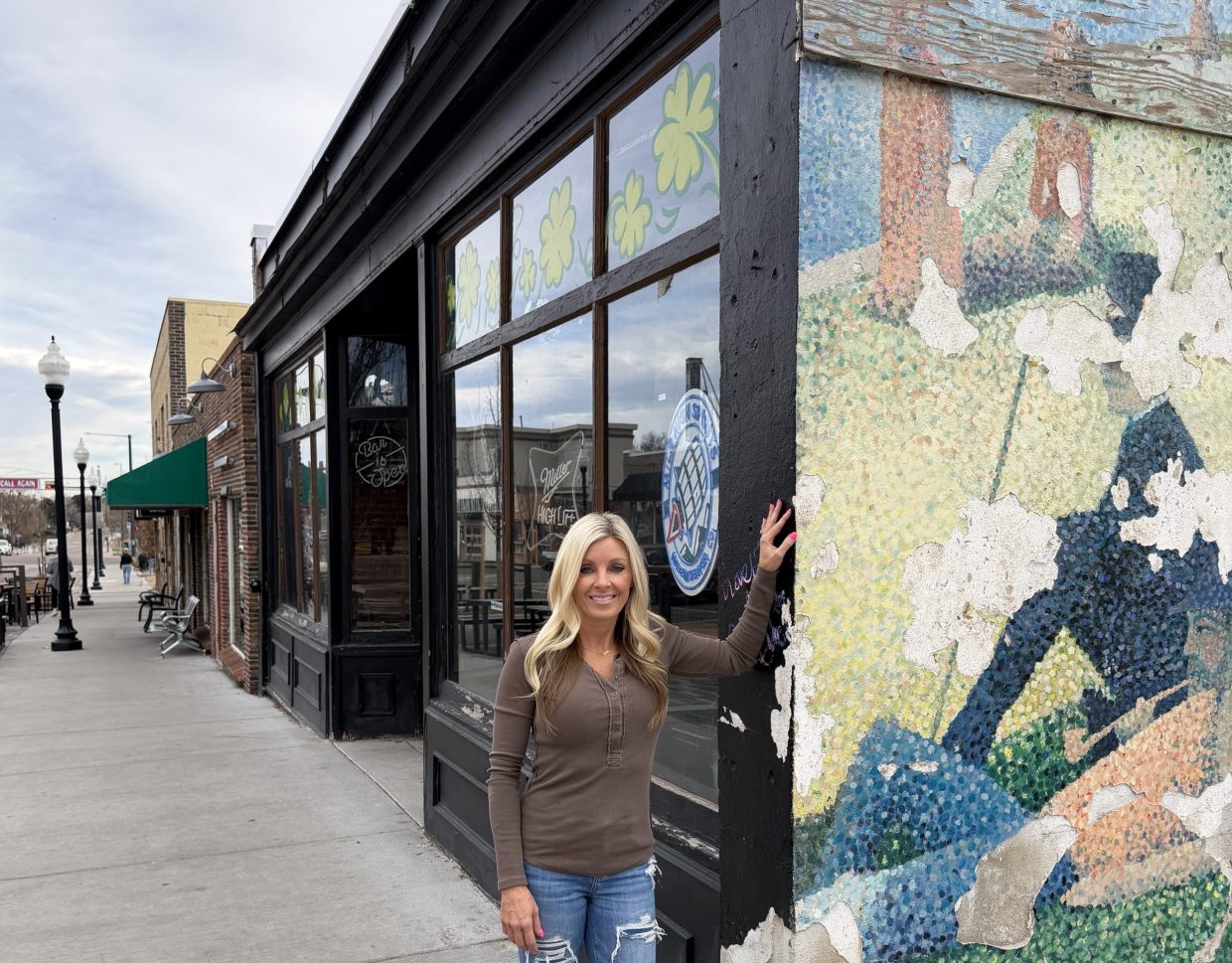 a women in front of a bar.