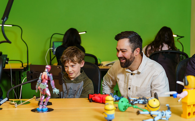 A man teaching a child about stop motion
