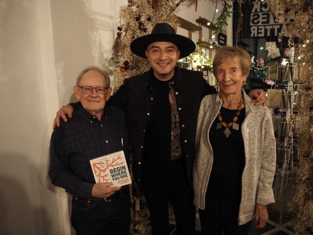 three people smile for a photo