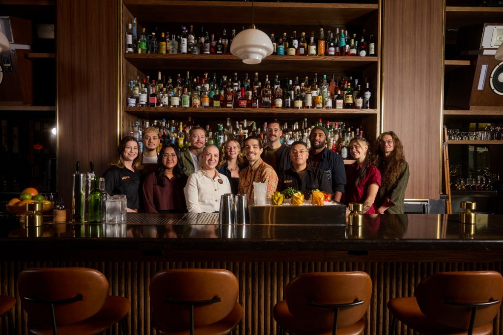 team of people standing behind a bar