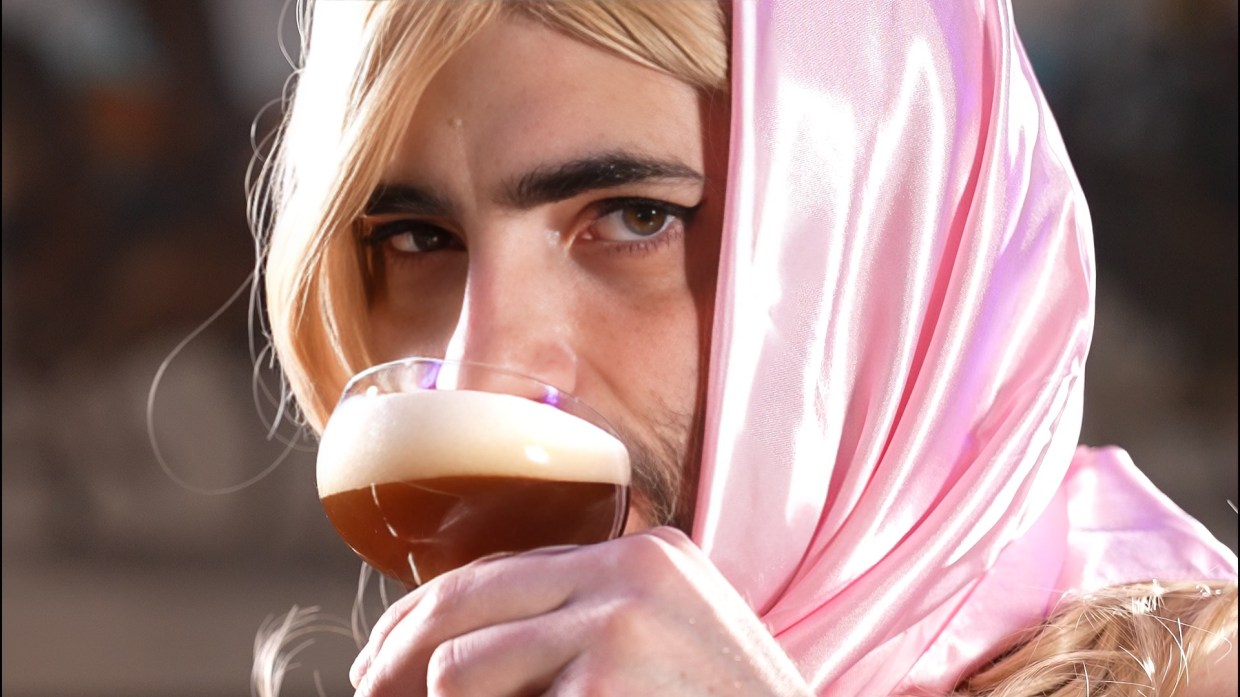 man dressed as Sabrina Carpenter, sipping espresso martini